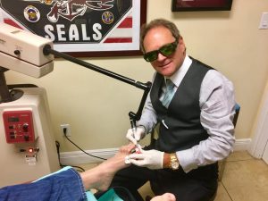 Dr. Goldbaum (pictured) using laser technology to treat toenail fungus.
