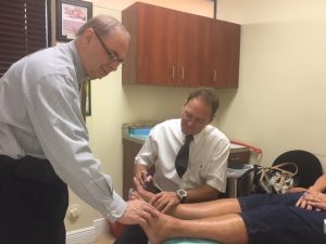 Dr. Larry J. Kipp (left) and Dr. Ian S. Goldbaum treating a patient at the Neuropathy Treatment Center.